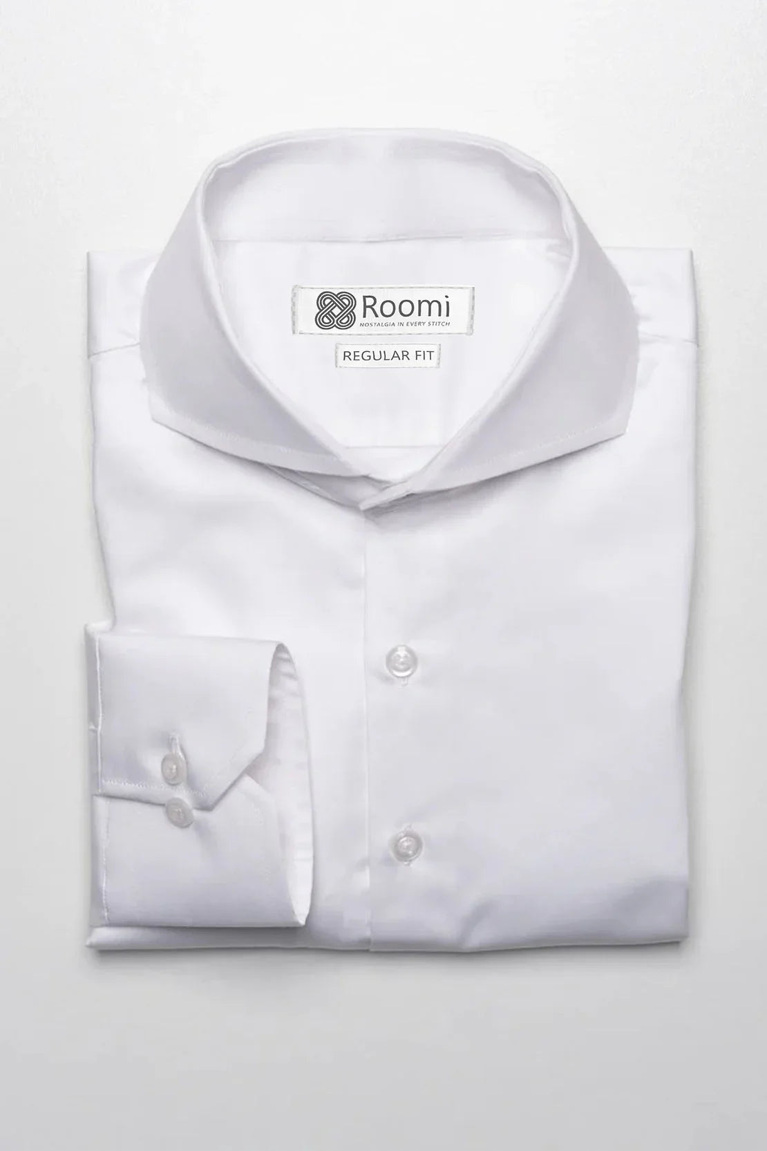 Folded white Roomi regular fit dress shirt with buttoned cuff on white background