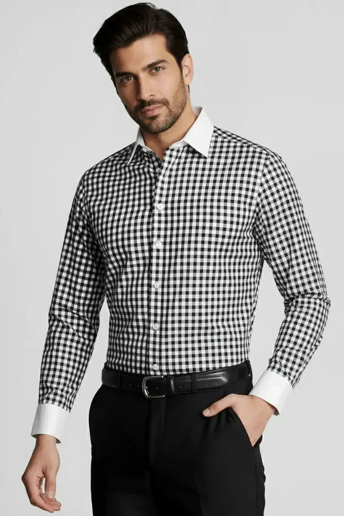 Man wearing black and white checkered formal shirt with white collar and cuffs, paired with black pants