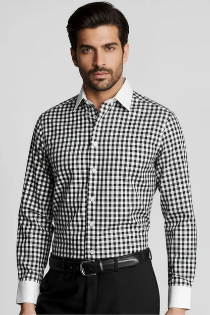 Man wearing black and white checked formal shirt with white collar and cuffs, black belt, and black pants