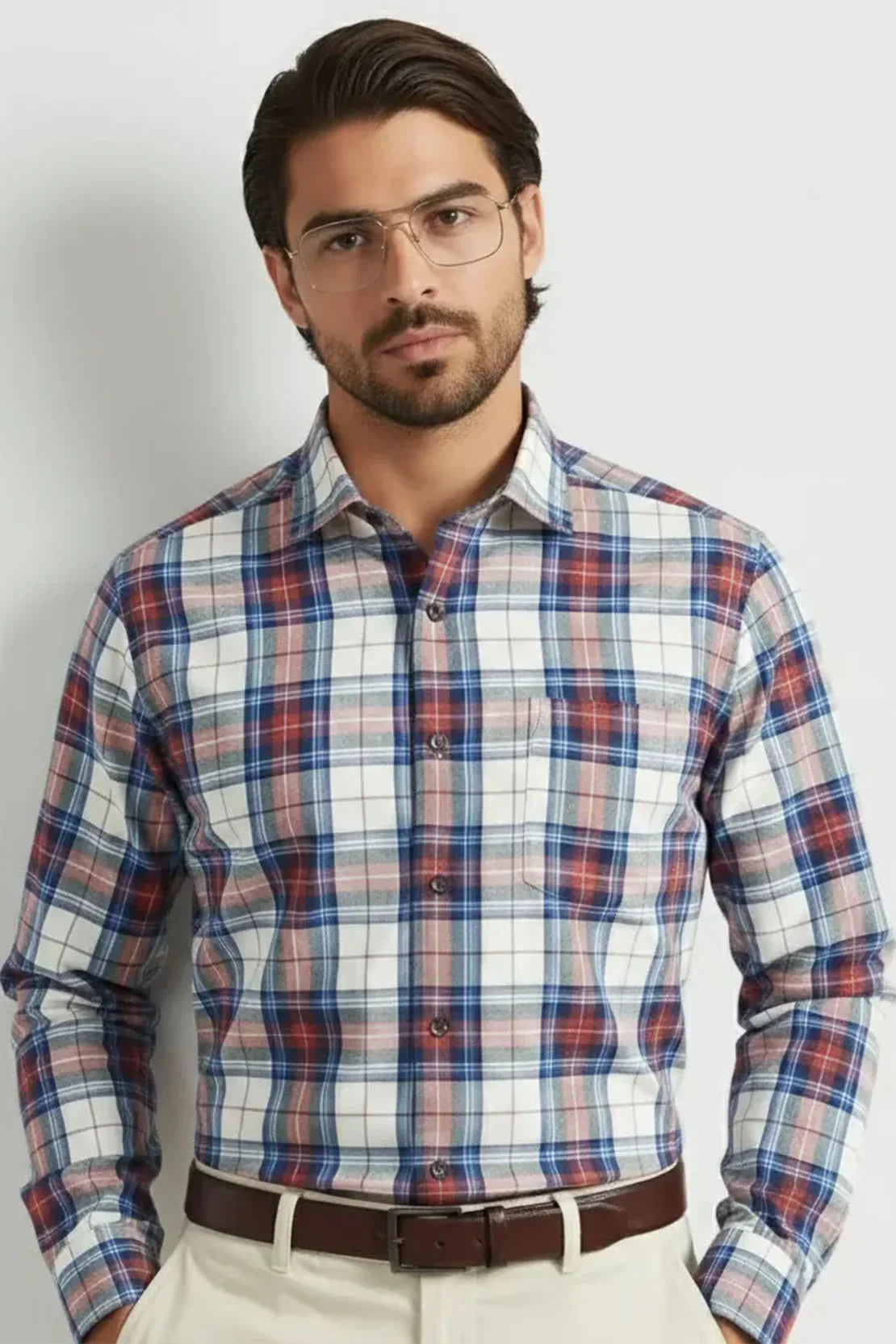Man wearing checkered long-sleeve shirt in blue, red, and white tones with beige pants and brown belt