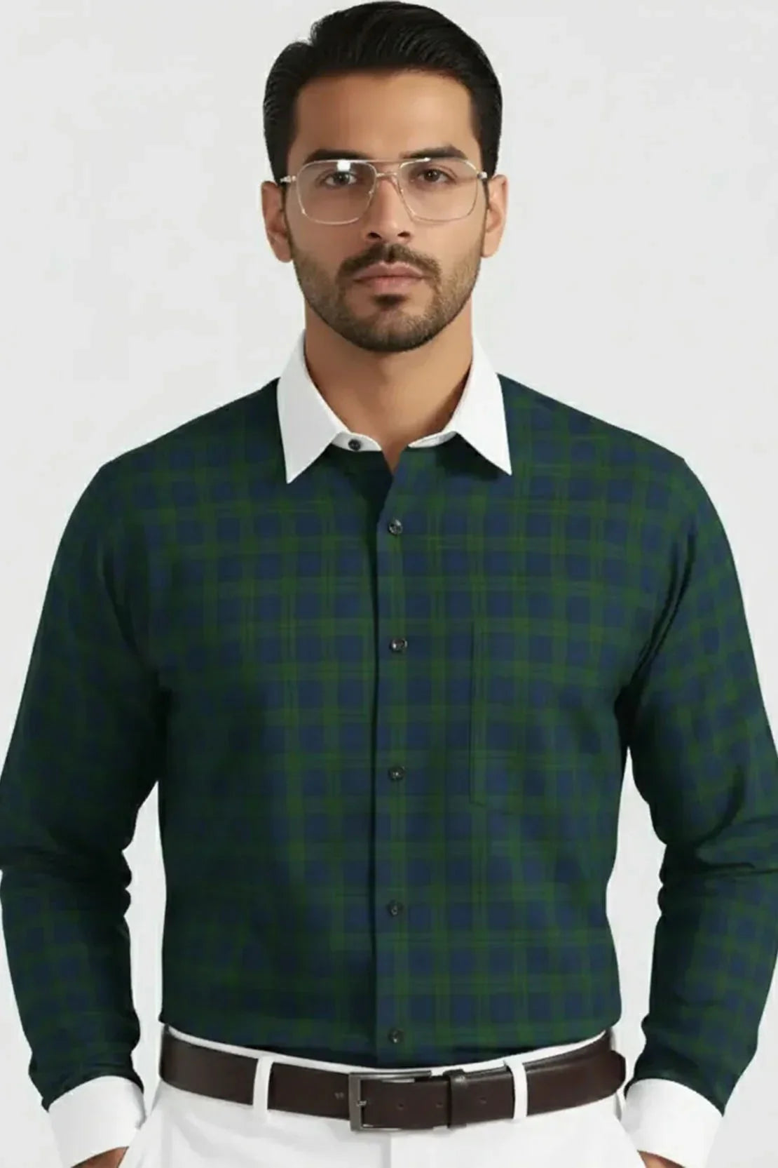 Man wearing green and navy checkered shirt with white collar and cuffs, brown belt, and glasses