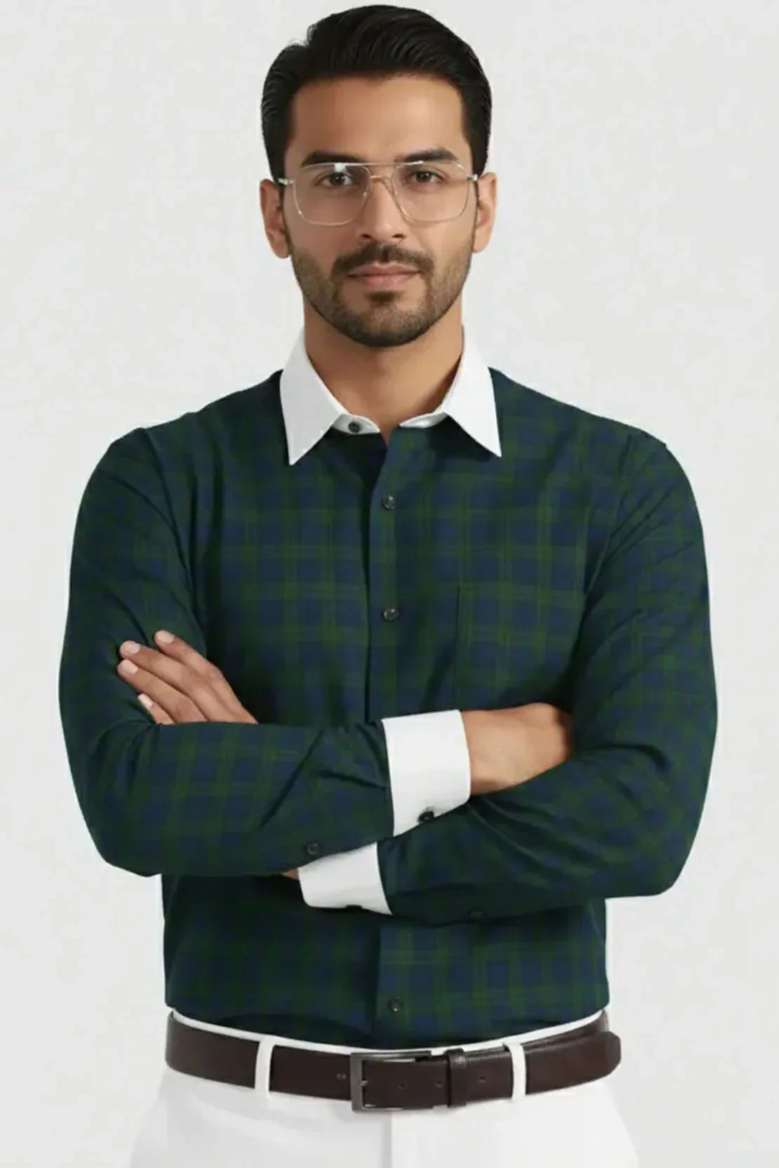 Man wearing green checkered shirt with white collar and cuffs, clear glasses, and brown belt